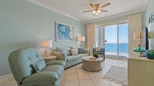 a living room with a couch and chairs and a television at Island Royale P202 in Gulf Shores