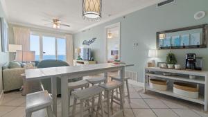 a kitchen and living room with a table and chairs at Island Royale P202 in Gulf Shores