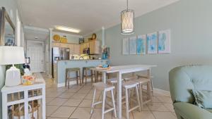 a kitchen and living room with a table and chairs at Island Royale P202 in Gulf Shores