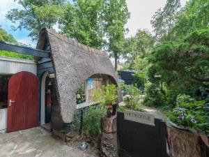 a small house with a red door and a garden at Holiday Home Bergen near Forest & Beach in Bergen