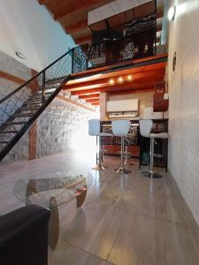 a living room with a staircase and a table and chairs at Hospedaje Diego Fabián in Antofagasta de la Sierra