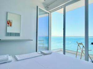 a white table with a view of the ocean at Megi's apartment in Shëngjin