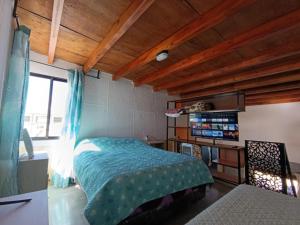 a bedroom with a bed in a room with wooden ceilings at Hospedaje Diego Fabián in Antofagasta de la Sierra