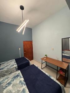 a bedroom with a bed and a wooden table at Casa climatizada Coatza in Coatzacoalcos