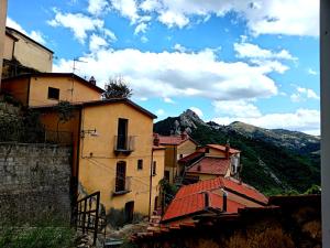 a group of buildings with mountains in the background at Il Glicine 2 in Castelmezzano