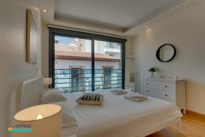 Ένα ή περισσότερα κρεβάτια σε δωμάτιο στο Dios Ponte 102 Beachfront