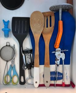 a group of kitchen utensils sitting on top of a counter at El Porteño in San Pedro +30 photos