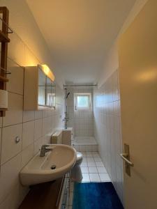 a bathroom with a sink and a toilet at Entspannendes Seestadt Apartment in Bremerhaven