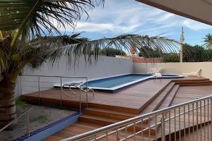 a deck with a swimming pool on top of a house at Flat praia a beira-mar in Natal
