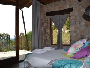 a bedroom with a large bed and a balcony at Belvilla by OYO Cobert de l'Era in Oden