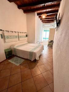 a bedroom with a large bed in a room at Note Sulla Piazza in Cagliari