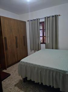 Ένα ή περισσότερα κρεβάτια σε δωμάτιο στο Casa Aconchegante