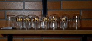 a row of empty glasses sitting on a table at Cottage Cozy Yard in Kazbegi