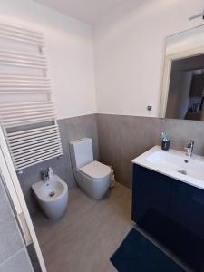 a bathroom with a toilet and a sink at Da Ciro e Angela in Barolo