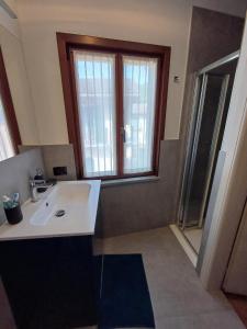 a bathroom with a sink and a window at Da Ciro e Angela in Barolo