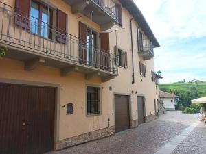a building with two garage doors on a street at Da Ciro e Angela in Barolo
