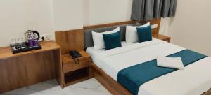 Ένα ή περισσότερα κρεβάτια σε δωμάτιο στο Hotel Sai Executive