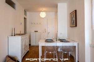 a dining room with a white table and chairs at Dipinto di blù by PortofinoVip in Santa Margherita Ligure +33 photos