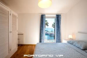 a bedroom with a bed and a view of the ocean at Dipinto di blù by PortofinoVip in Santa Margherita Ligure