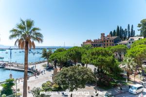 a view of a beach with palm trees and water at Dipinto di blù by PortofinoVip in Santa Margherita Ligure