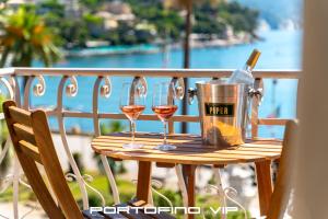 a table with two glasses of wine and a bucket at Dipinto di blù by PortofinoVip in Santa Margherita Ligure