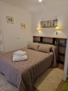 a bedroom with a bed with two towels on it at La Casona in Redondela