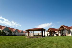 a large building with a gazebo in a field at Cedar Shore Resort in Oacoma