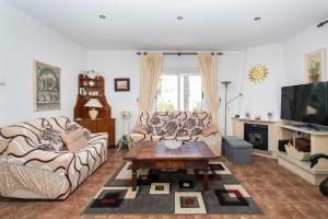 a living room with two couches and a coffee table at CH Villa Jupiter La Marquesa in Rojales