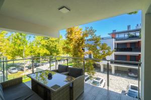 a view from the balcony of a house with a table and chairs at Sunshine Resort Blue Apartman in Zamárdi