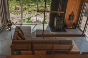 a living room with a couch and a stove at La Havre Gris - Relax and enjoy in Grande Vallee