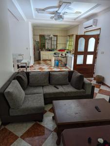 a living room with a couch and a kitchen at Villa bouisville ain el turk oran in Trouville