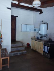 a room with a stove and stairs in a building at Sol de Maimará in Maimará