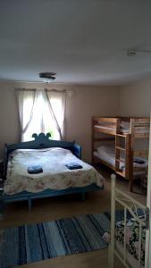 a bedroom with a bed and a window and a crib at Majatalo Martta in Nauvo