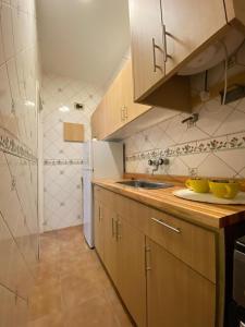 a kitchen with a sink and a counter top at Departamento Las Heras in Mar del Plata +4 photos
