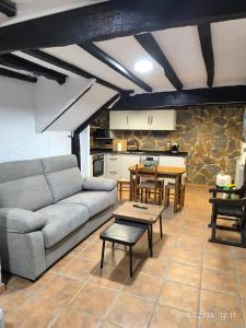 a living room with a couch and a table at La Casa de la Miel in Ramales de la Victoria