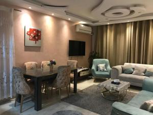 a living room with a table and chairs and a couch at كمبوند جنة زايد 1 in Sheikh Zayed