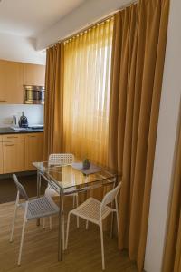 a dining room with a glass table and chairs at Aparthotel Bianca in Vienna in Vienna +19 photos