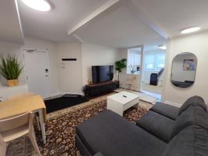 a living room with a couch and a tv at Byward Market Downtown Guesthouse in Ottawa