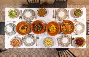 a bunch of different types of food in bowls on a table at Riad Benyara in Taroudant