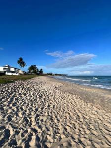 プライア・ドス・カルネイロスにあるBela Casa Praia dos Carneiros Condominio Beira Mar Seg 24hrs FRENTE PISCINAS NATURAIS!!!のヤシの木と海の砂浜