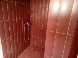 a bathroom with a shower with red tile at Vicente House in Skala Rachoniou +44 photos