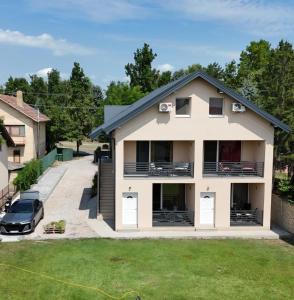 a house with a car parked in front of it at SOBE AVA in Palić