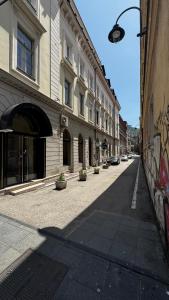 an empty street in a city with buildings at Spacious apartment in the city centre in Sarajevo