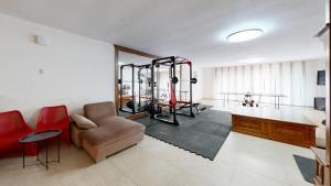 a living room with a gym with a couch and a chair at RODINNÁ VILA - STARÉ SPLAVY, Máchovo jezero in Staré Splavy