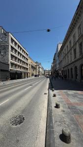 an empty street in a city with buildings at Spacious apartment in the city centre in Sarajevo
