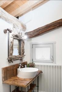 a bathroom with a sink and a mirror at A casa di Sophi Lago Maggiore Private outdoor Sauna in Angera +14 photos