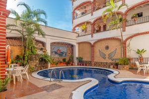 a swimming pool in the middle of a building at Departamento Cielo in Puerto Vallarta