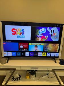 a flat screen tv sitting on top of a shelf at Luxe Living Prime Location in Kitchener