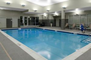 a large swimming pool with blue water at Courtyard by Marriott St. Louis West County in Saint Louis