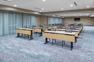 a room with rows of tables and chairs at Courtyard by Marriott St. Louis West County in Saint Louis